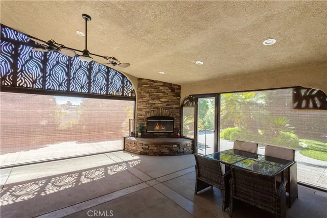 a living room with furniture a flat screen tv and a floor to ceiling window