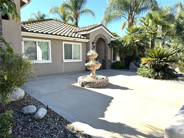 a front view of a house with a yard garage and outdoor seating