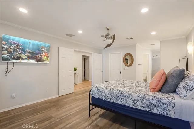 a bedroom with a large bed and a chandelier