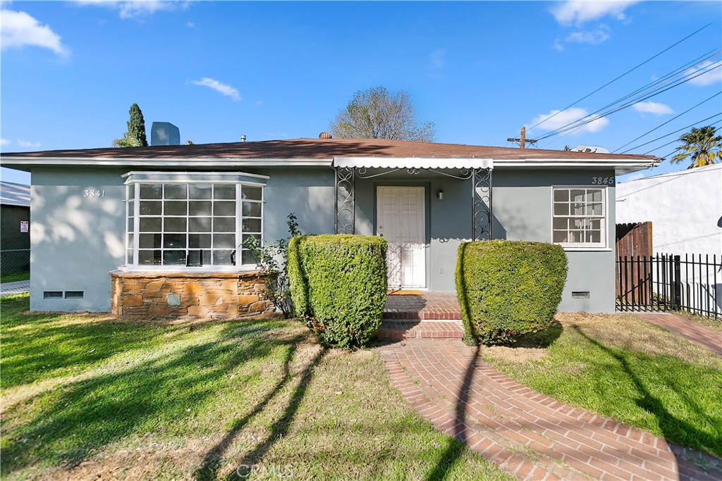 a view of a chairs in back yard of the house
