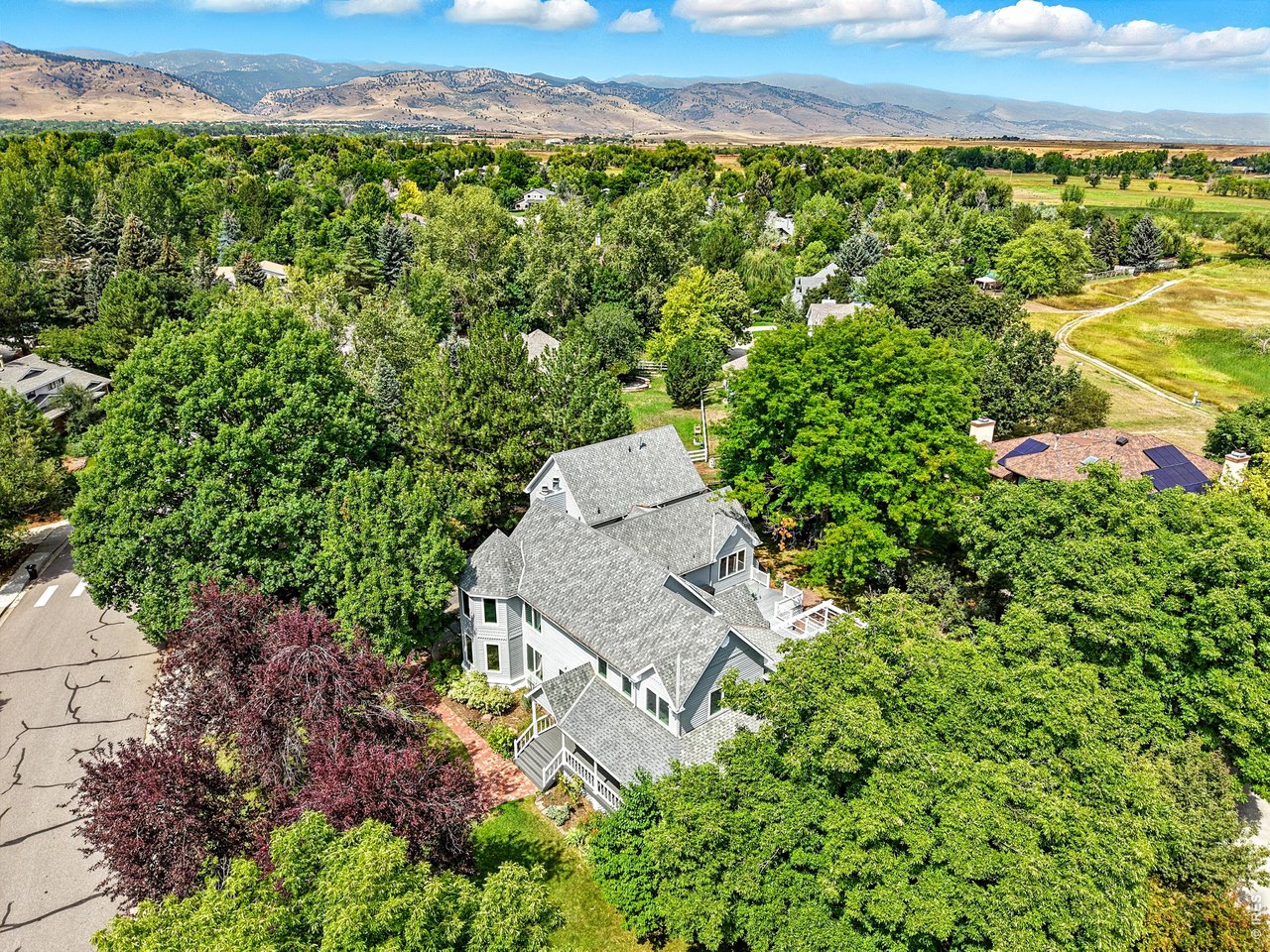 4557 Apple Way Boulder, CO 80301 - Photo 40 of 42 Set on a lush half-acre lot, the property feels private, open, and beautifully established. Trails, playgrounds, and neighborhood open space are just moments from your front door.