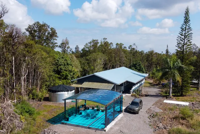 an aerial view of a house with outdoor space