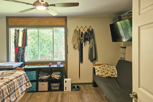 a bedroom with furniture and a window