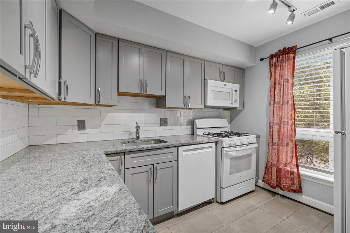 3940 Bel Pre Road, Unit 6 Silver Spring, MD 20906 - Photo 9 of 29 Modern kitchen with sleek finishes.