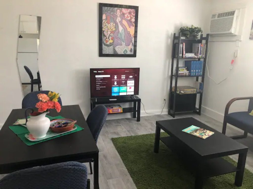 5909 Bolm Road, Unit 13 Austin, TX 78721 - Photo 6 of 10 Living area with light wood finished floors and a wall unit AC