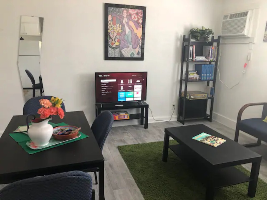 5909 Bolm Road, Unit 13 Austin, TX 78721 - Photo 6 of 10 Living area with light wood finished floors and a wall unit AC