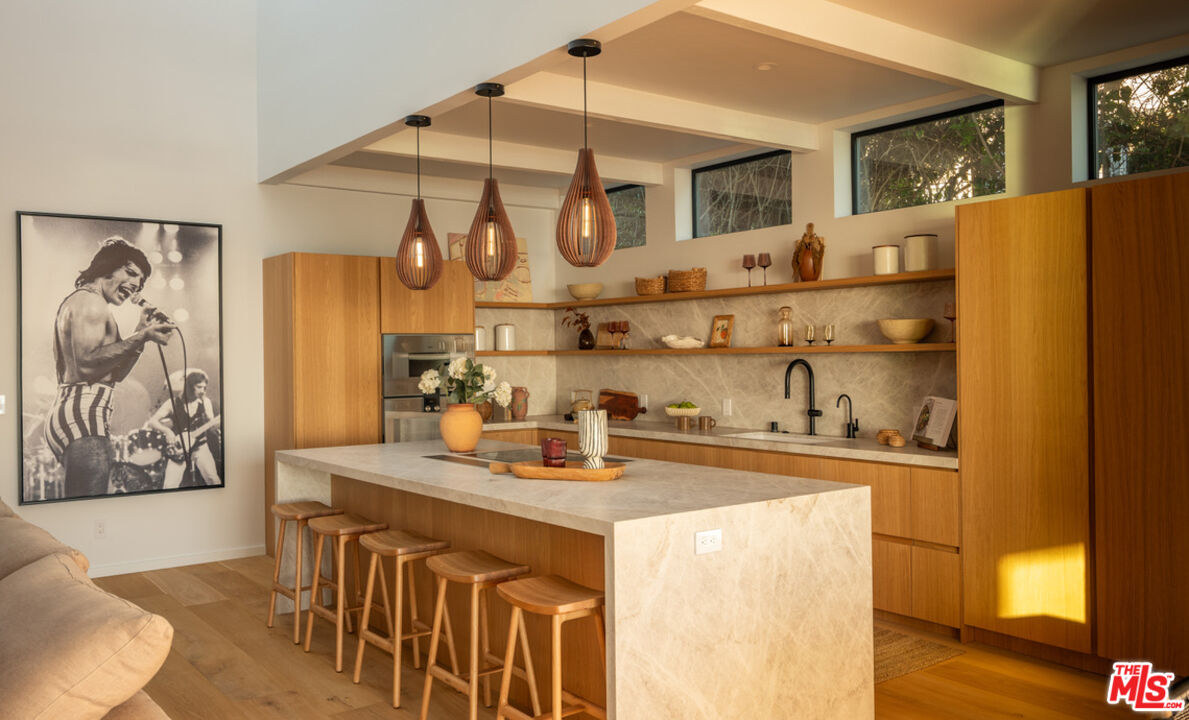 31376 Broad Beach Road Malibu, CA 90265 - Photo 10 of 32 a kitchen with stainless steel appliances granite countertop a sink a stove cabinets and wooden floor