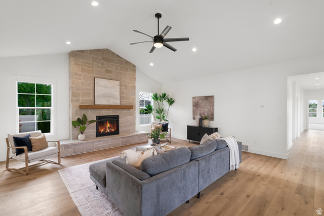 1952 South Comanche Circle Farmington, UT 84025 - Photo 19 of 52 Living area featuring light wood-style floors, healthy amount of natural light, a ceiling fan, a fireplace, and recessed lighting