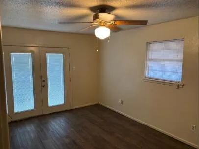 a view of empty room with wooden floor