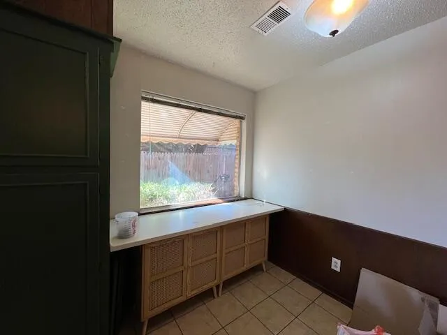 a kitchen with a window and cabinets