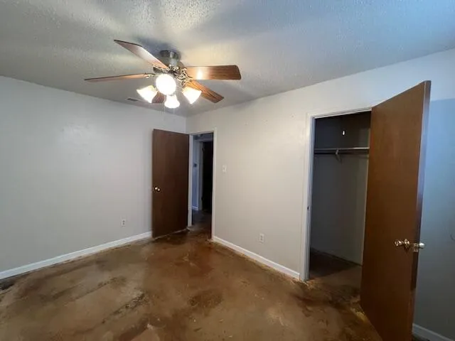 a view of an empty room and closet area