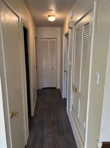 a view of hallway with wooden floor