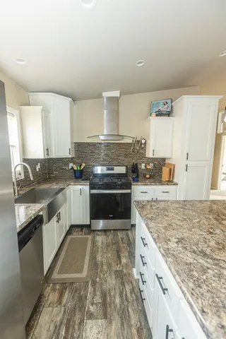 a view of a hallway to a room and a livingroom