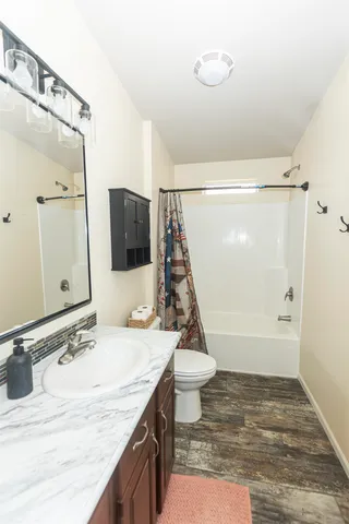 a bedroom with a granite countertop sink and mirror
