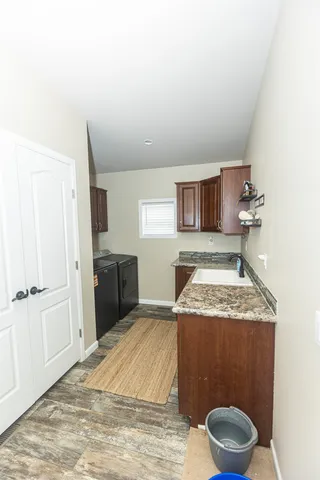 a spacious bathroom with a granite countertop sink and a mirror