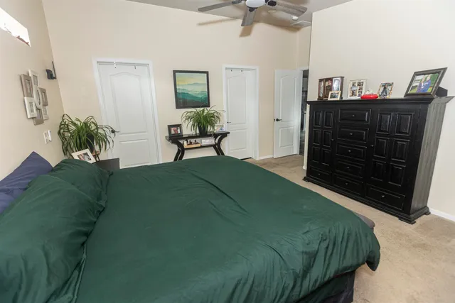 a bathroom with a granite countertop sink a mirror and a shower