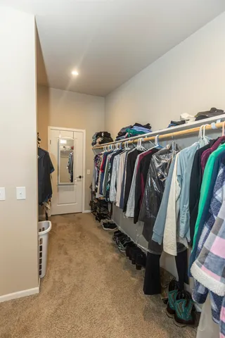 a spacious bathroom with a tub sink and mirror