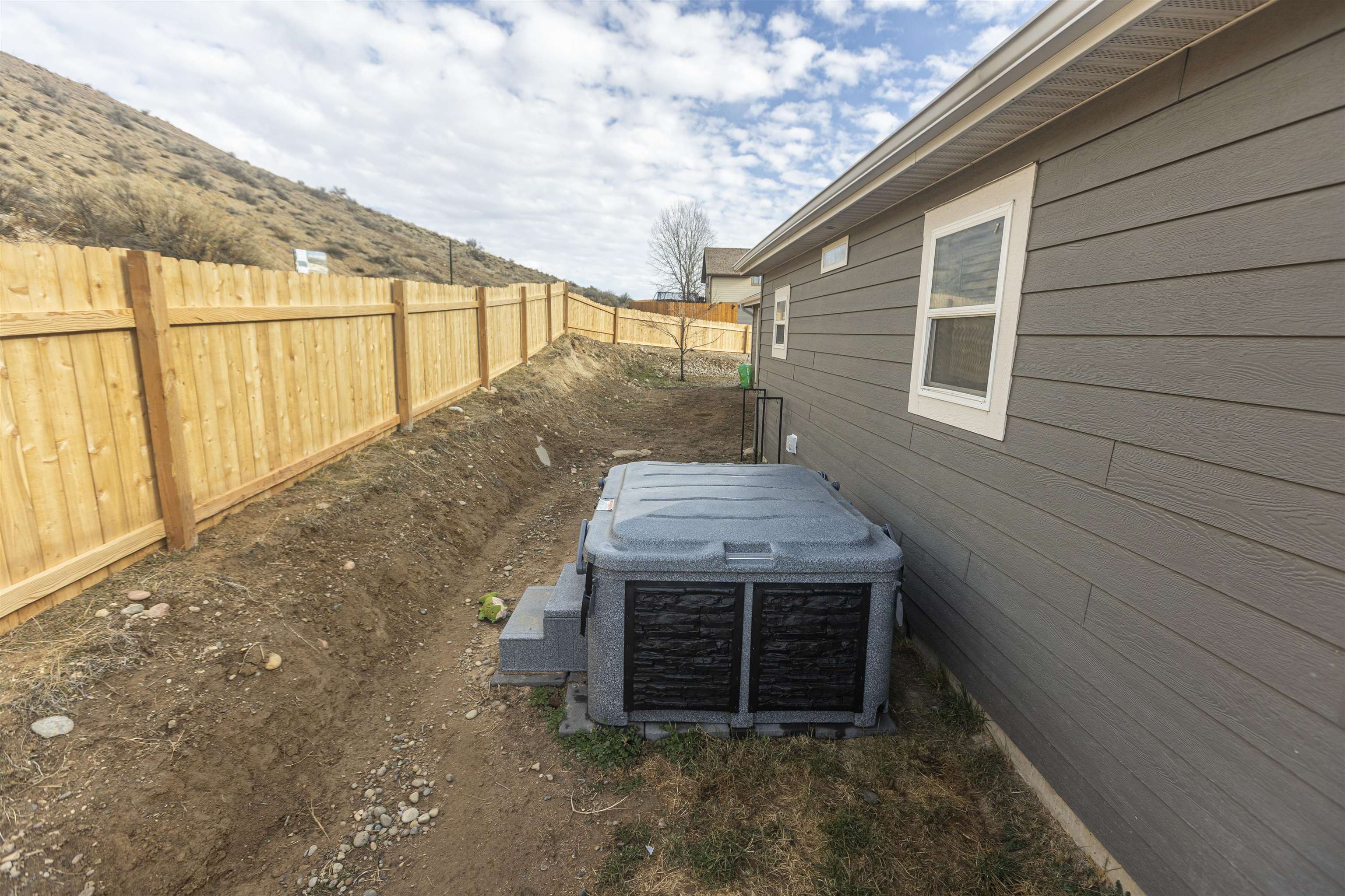 2432 Pioneer Way Rifle, CO 81650 - Photo 27 of 31 a view of a house with a door and wooden fence