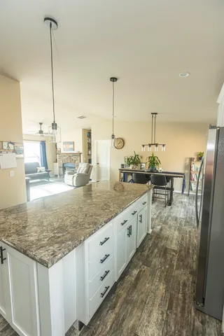 a kitchen with stainless steel appliances granite countertop a stove a sink and a granite counter tops
