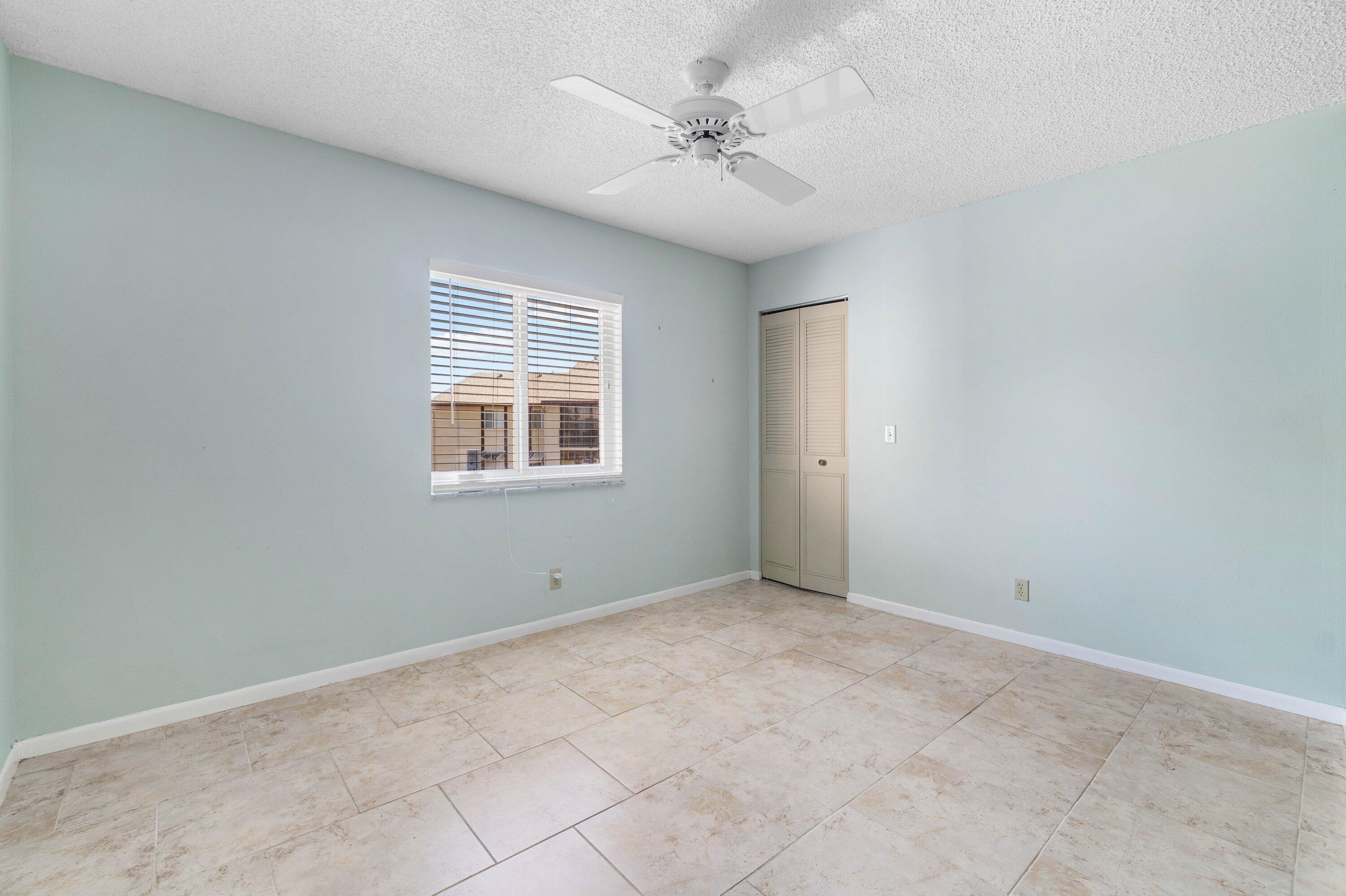 322 Pine Ridge Circle, Unit A2 Greenacres, FL 33463 - Photo 15 of 26 an empty room with windows and fan