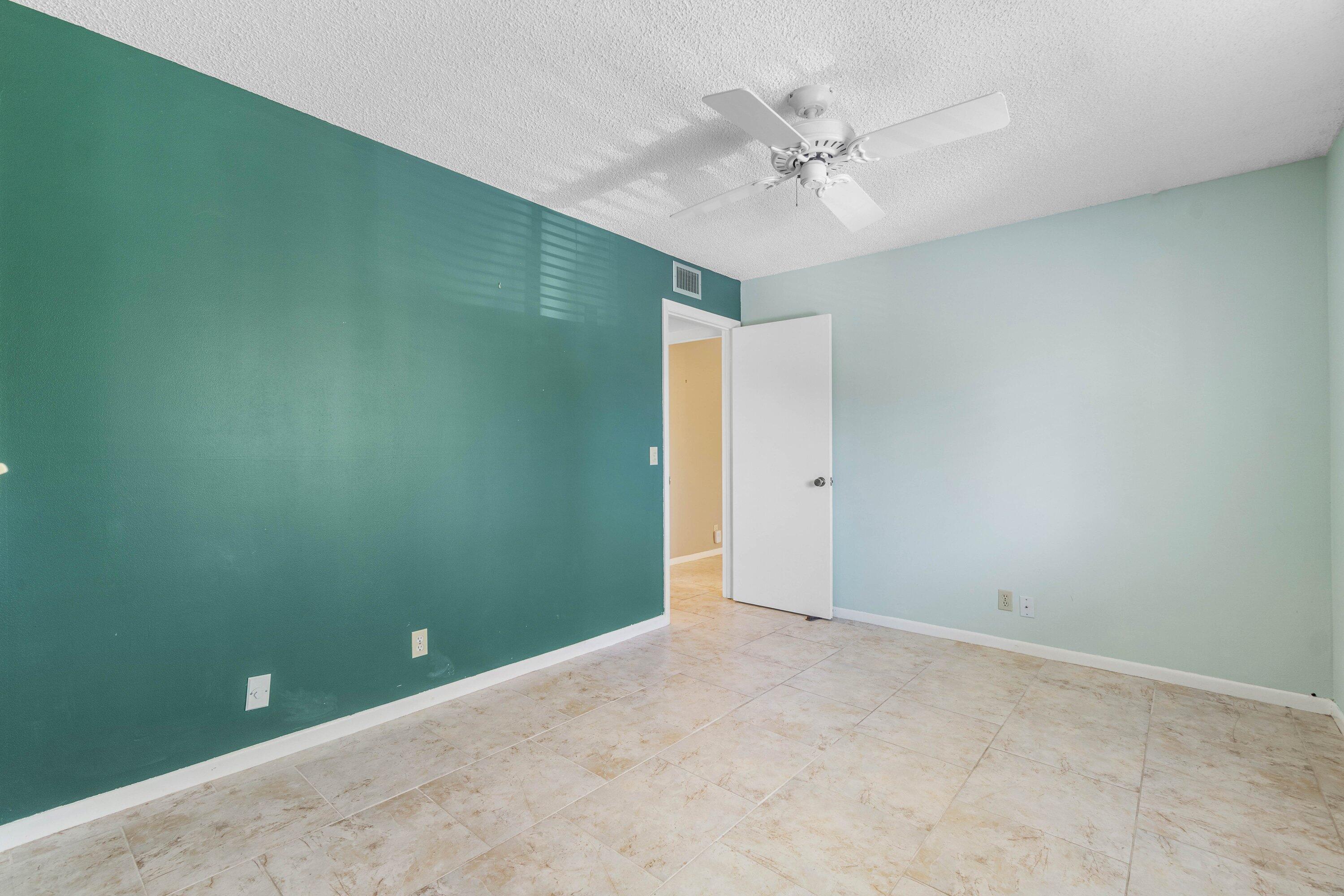 322 Pine Ridge Circle, Unit A2 Greenacres, FL 33463 - Photo 16 of 26 an empty room and chandelier fan