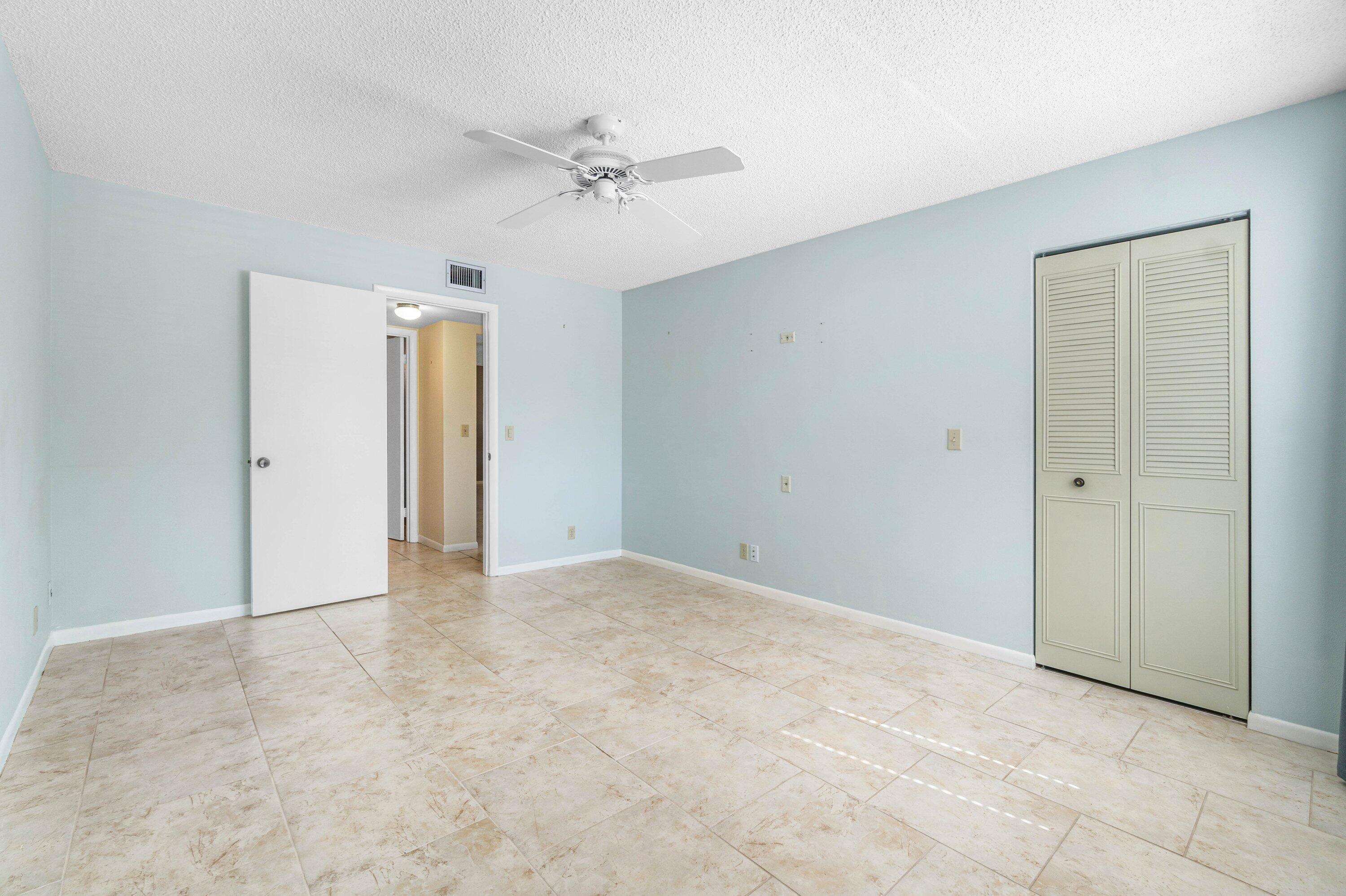 322 Pine Ridge Circle, Unit A2 Greenacres, FL 33463 - Photo 19 of 26 a view of an empty room with a fan
