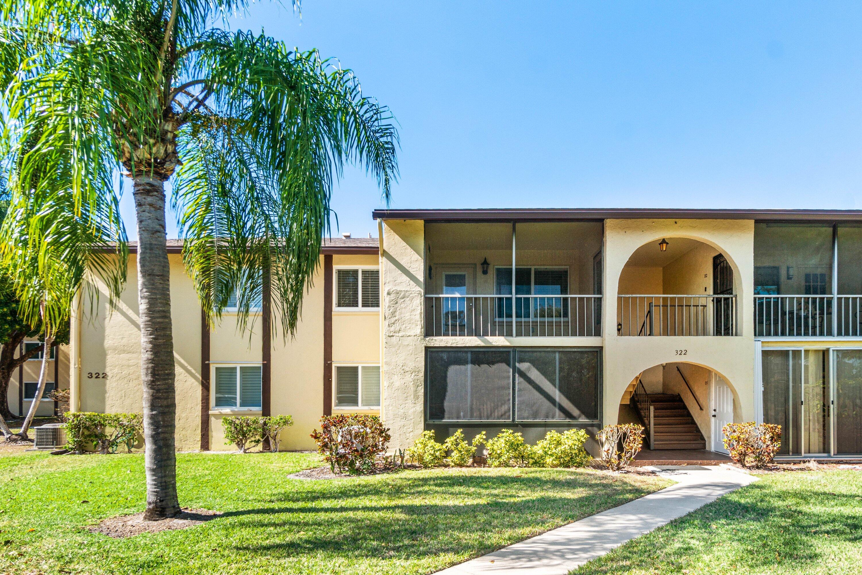 322 Pine Ridge Circle, Unit A2 Greenacres, FL 33463 - Photo 2 of 26 a front view of a house with garden