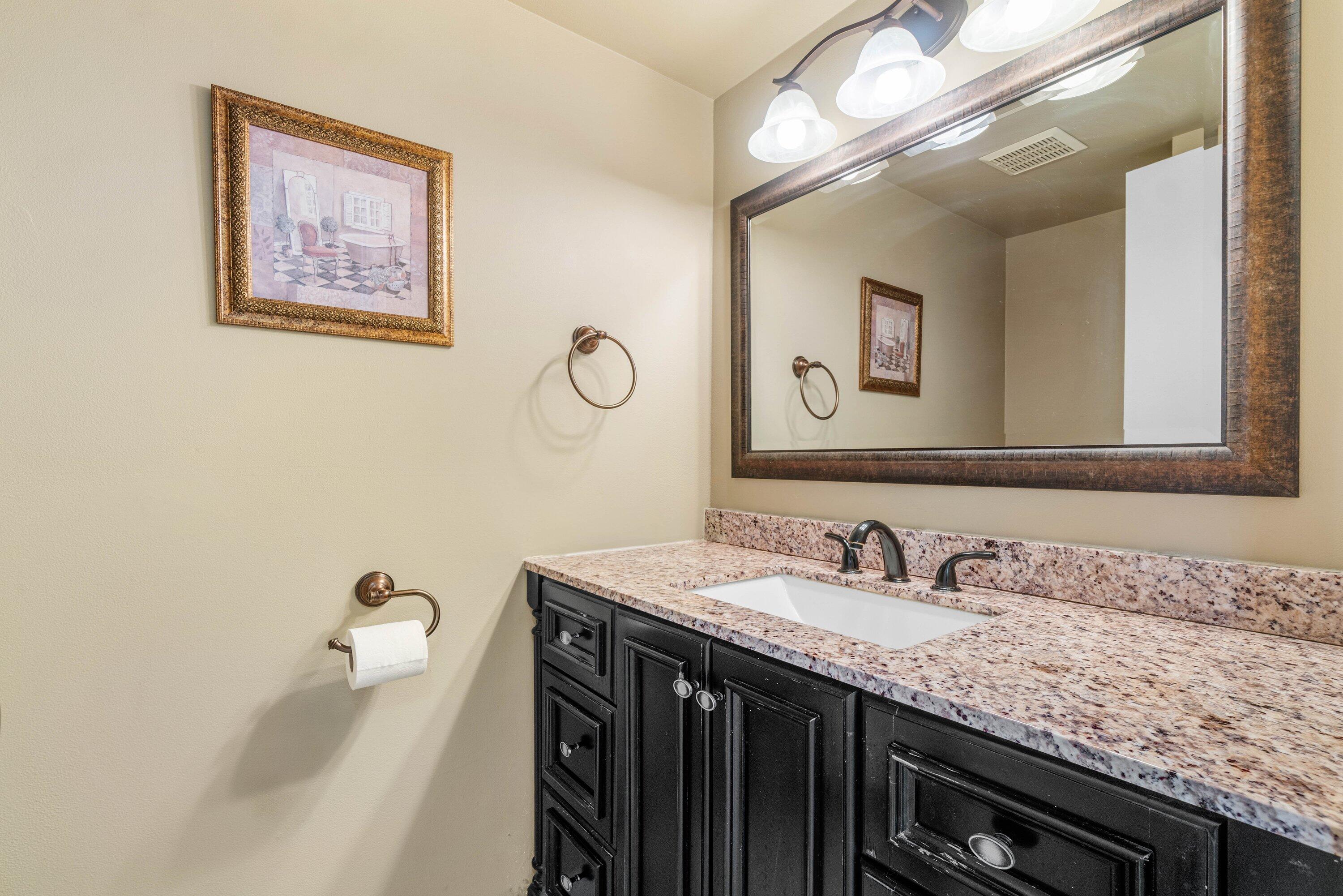 322 Pine Ridge Circle, Unit A2 Greenacres, FL 33463 - Photo 21 of 26 a bathroom with a granite countertop sink a large mirror and a