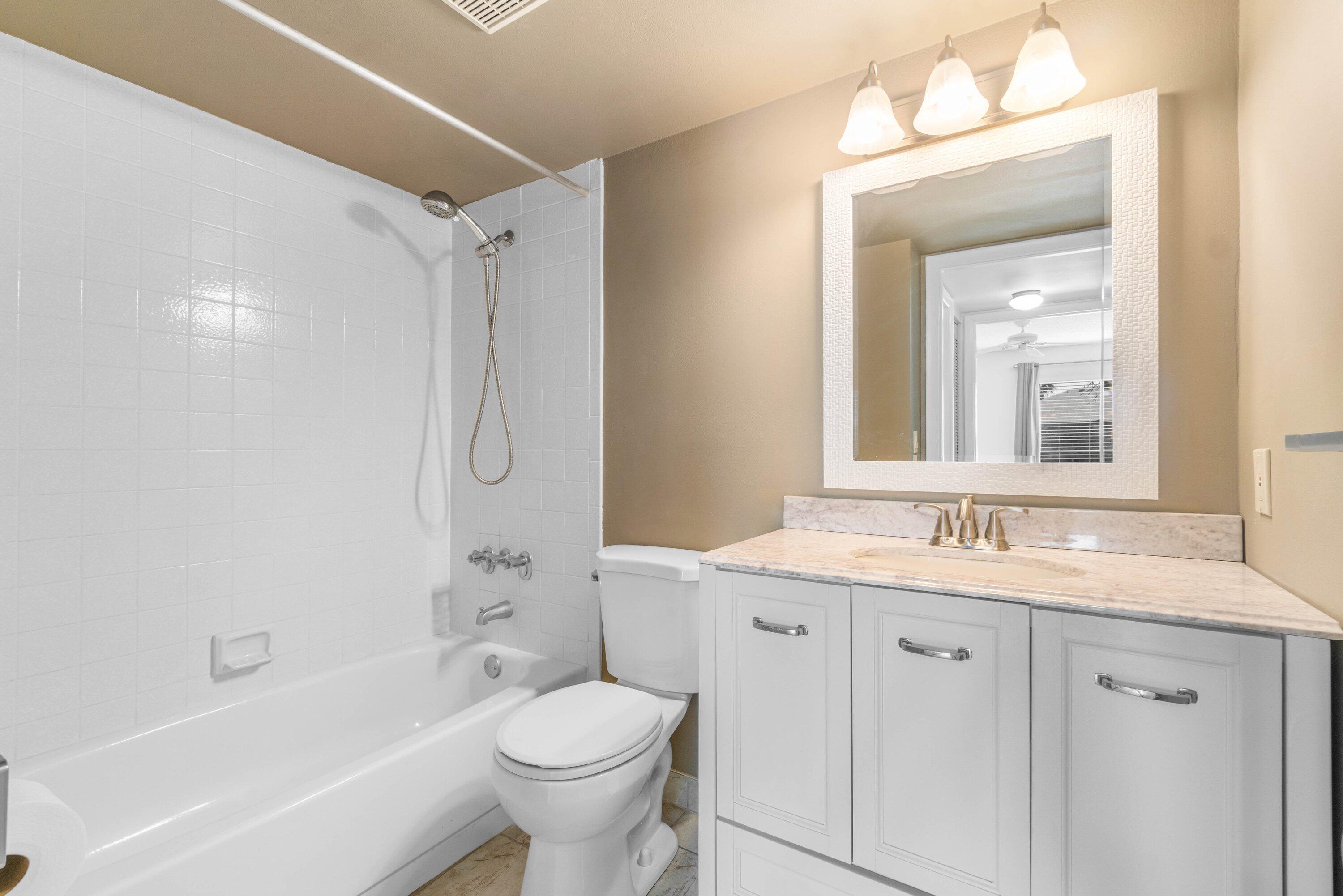 322 Pine Ridge Circle, Unit A2 Greenacres, FL 33463 - Photo 22 of 26 a bathroom with a granite countertop sink toilet and shower