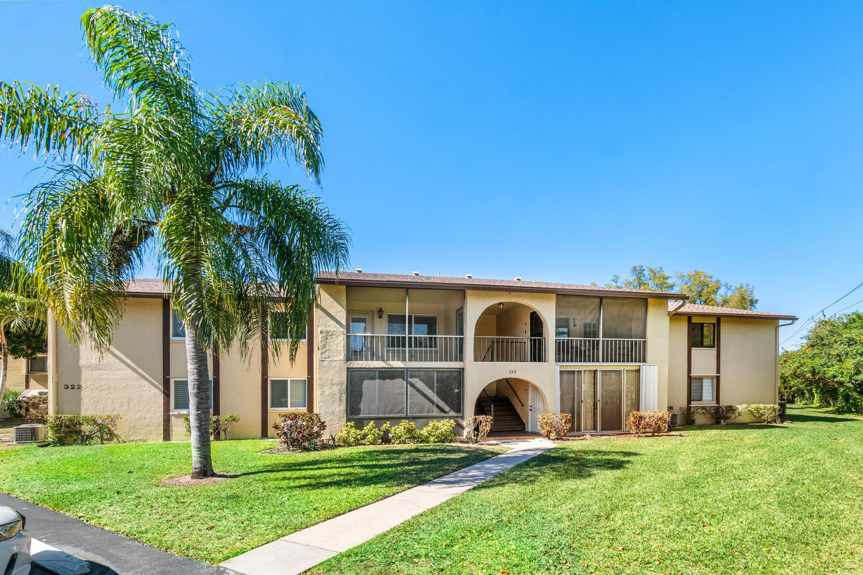 322 Pine Ridge Circle, Unit A2 Greenacres, FL 33463 - Photo 3 of 26 a view of front of house with yard