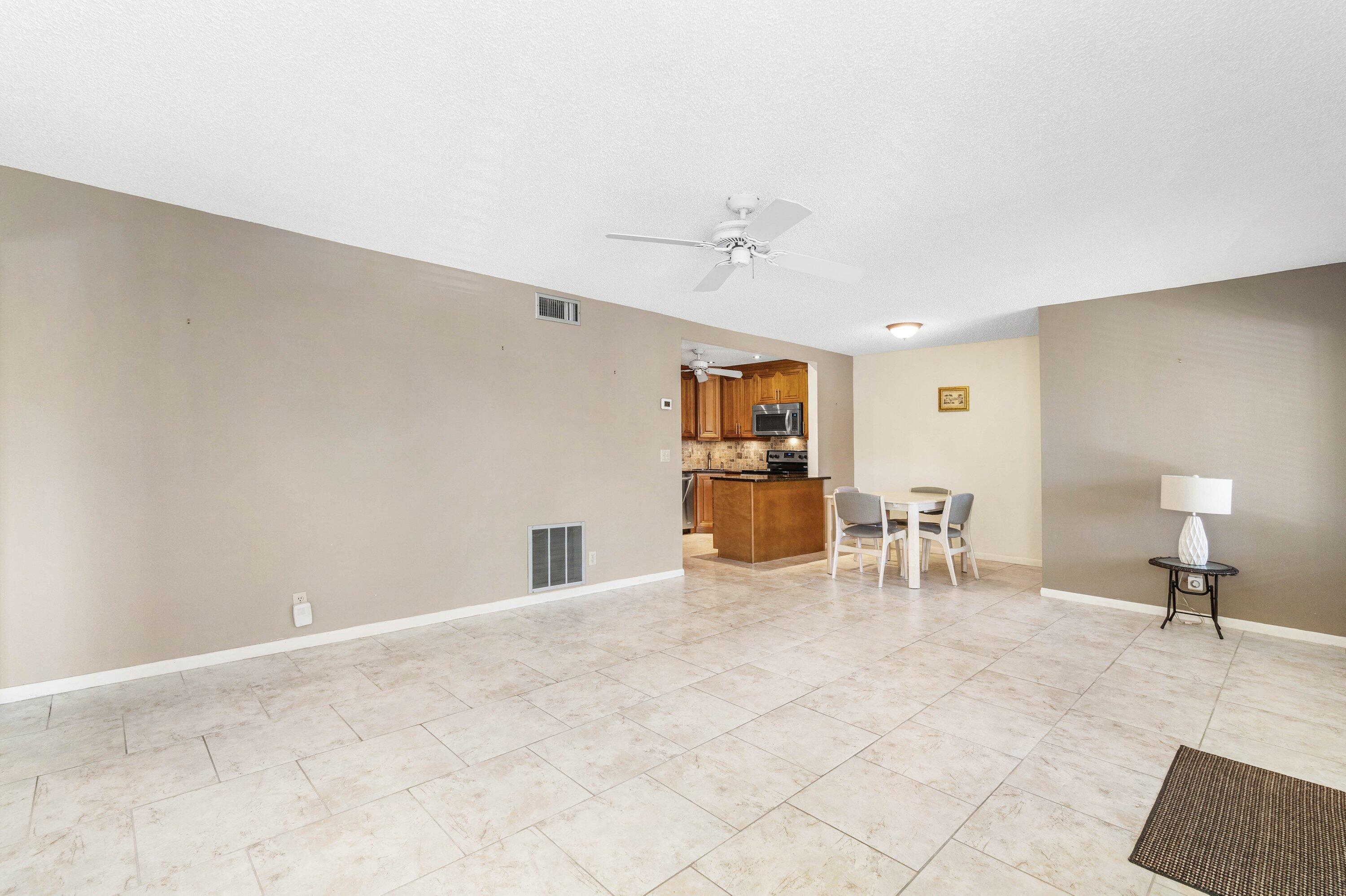 322 Pine Ridge Circle, Unit A2 Greenacres, FL 33463 - Photo 8 of 26 a view of a livingroom with furniture and a couch