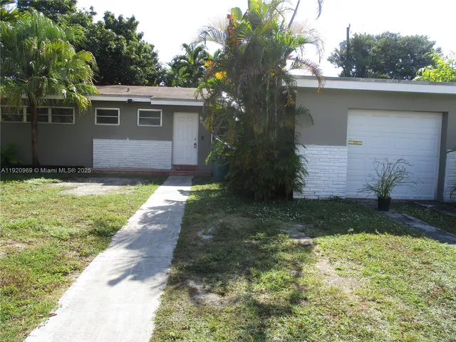 a backyard of a house with potted plants and large trees