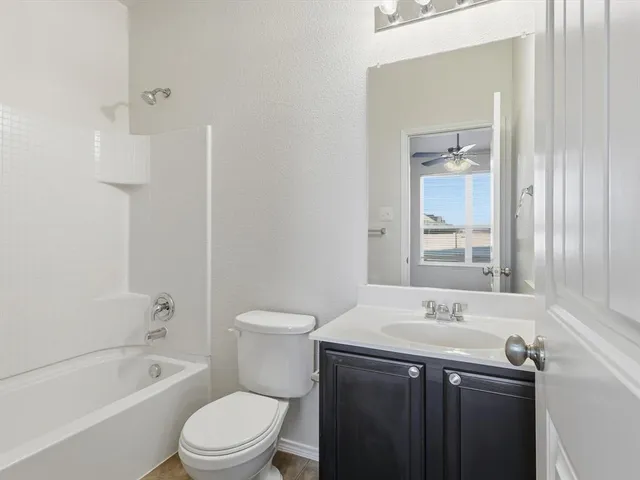 a bathroom with a sink a toilet and bathtub