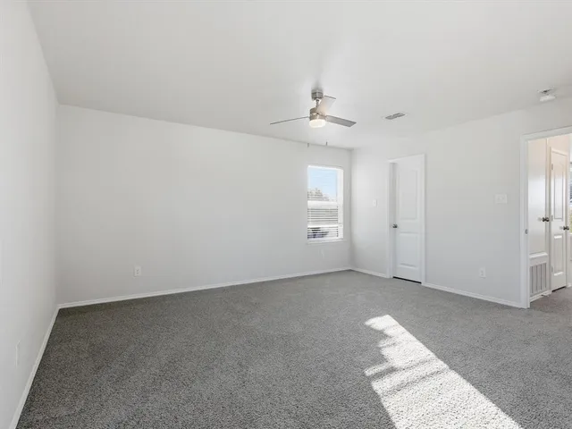 an empty room with a empty space and windows