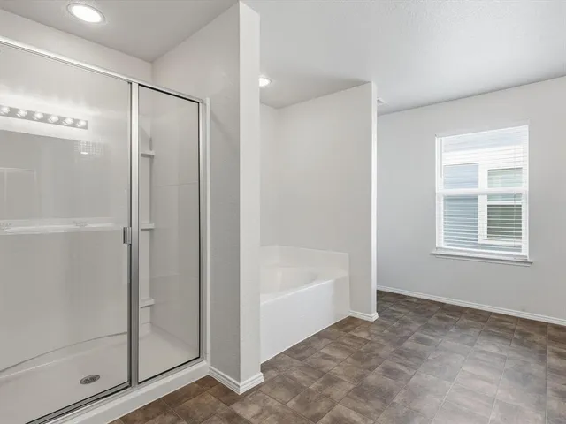 a bathroom with a bathtub and a shower