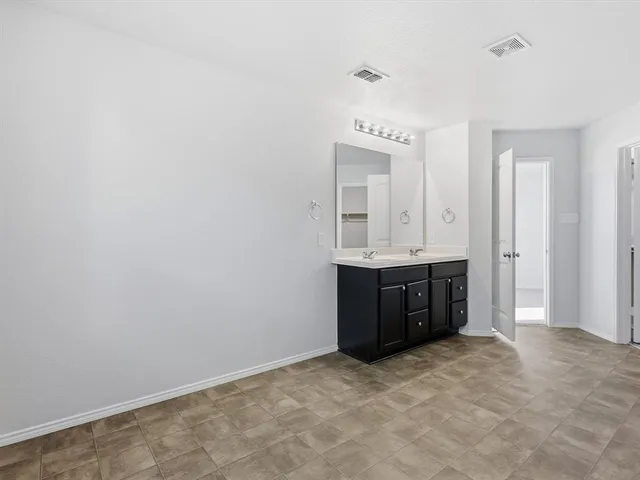 a bathroom with a sink vanity and mirror
