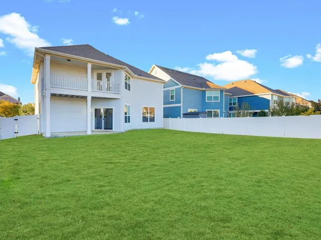 a front view of a house with a garden and yard