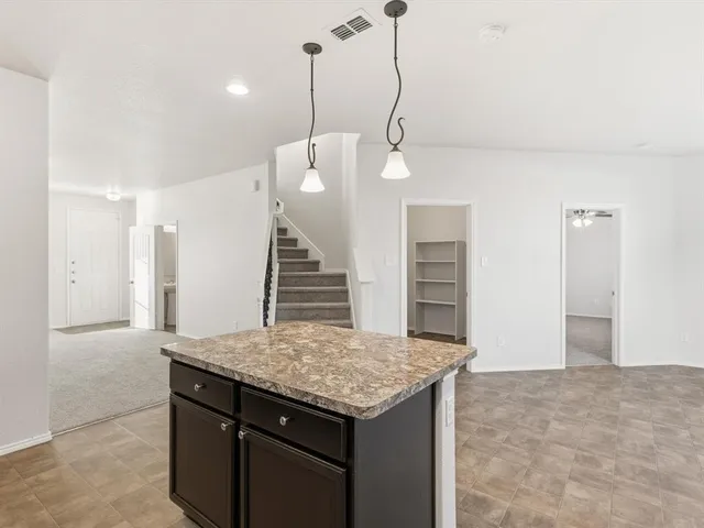 a kitchen with a table and chairs