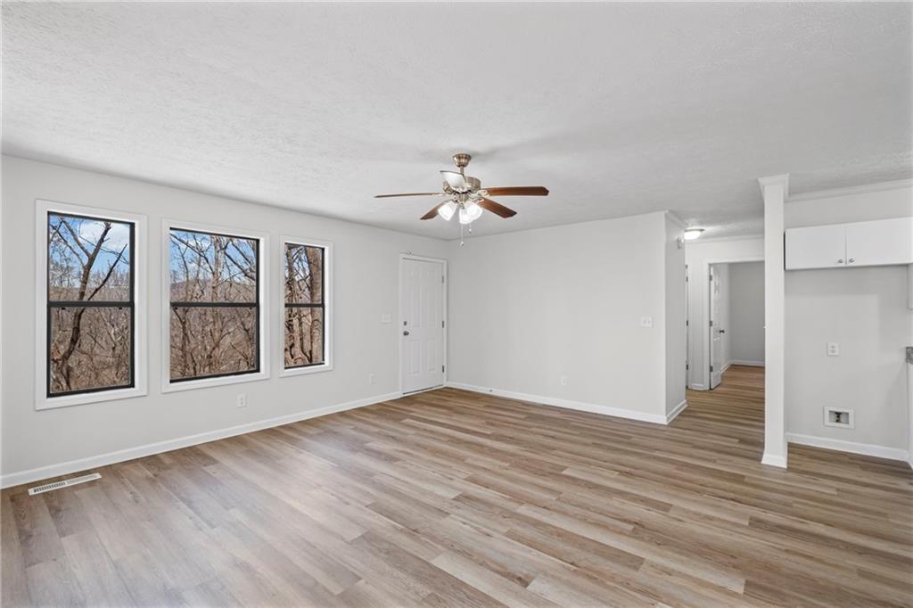 764 Chestnut Cove Trail Jasper, GA 30143 - Photo 18 of 44 a view of an empty room with a window and wooden floor