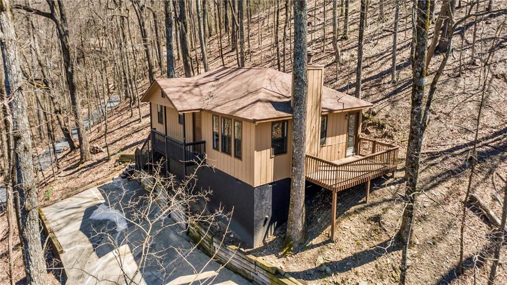 764 Chestnut Cove Trail Jasper, GA 30143 - Photo 6 of 44 a view of a white house with a large tree