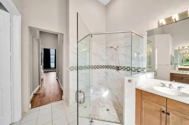 a bathroom with a double vanity sink a mirror and shower