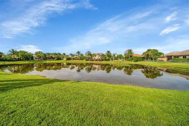a view of a lake with houses in the background
