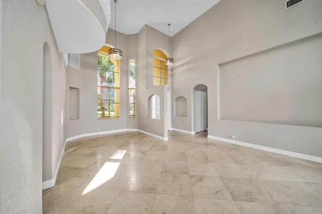 a view of an empty room with windows