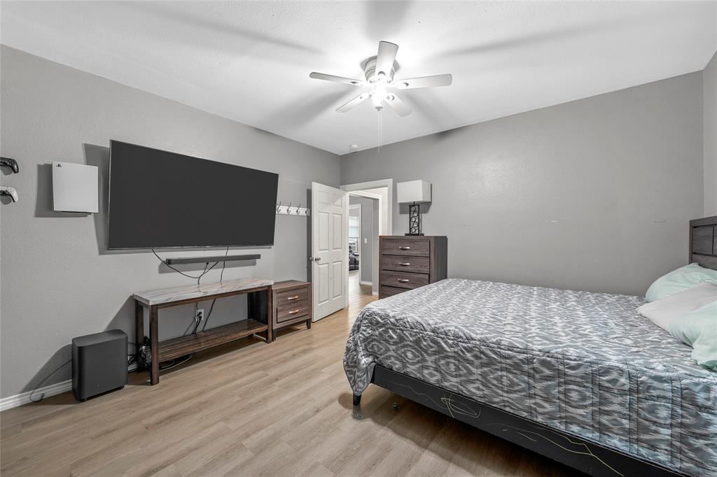 2301 Herring Avenue Waco, TX 76708 - Photo 11 of 14 a bedroom with a bed and a flat screen tv