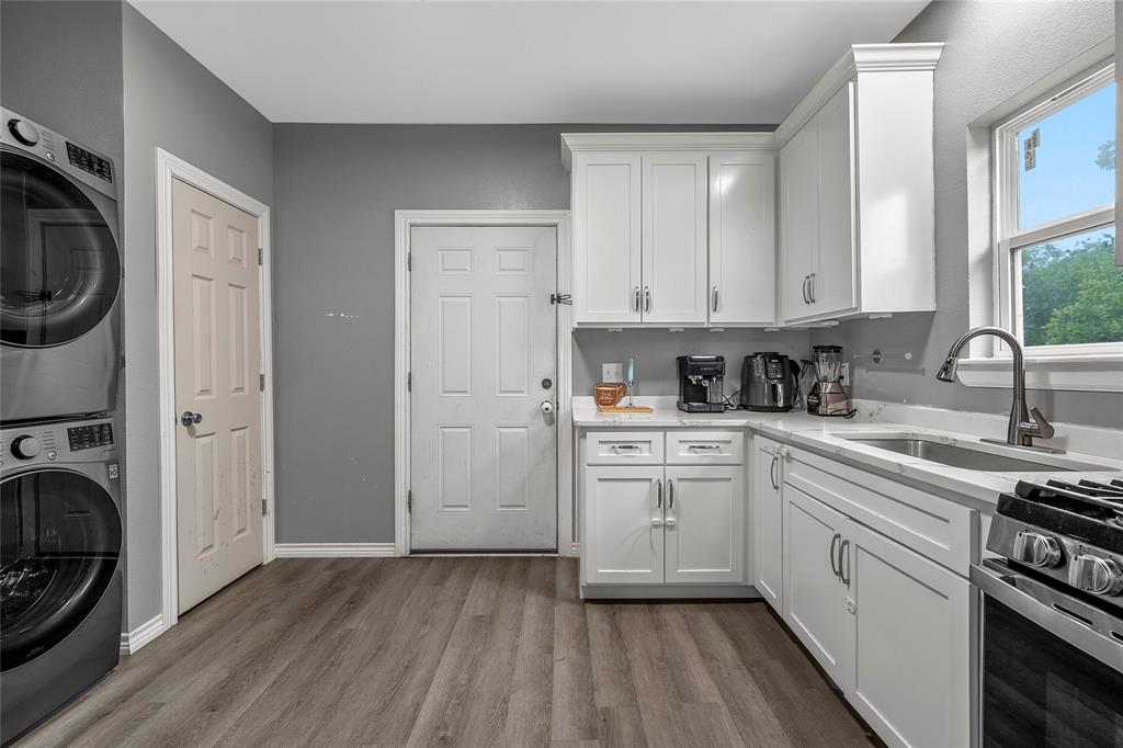 2301 Herring Avenue Waco, TX 76708 - Photo 7 of 14 a kitchen with a sink a stove and cabinets