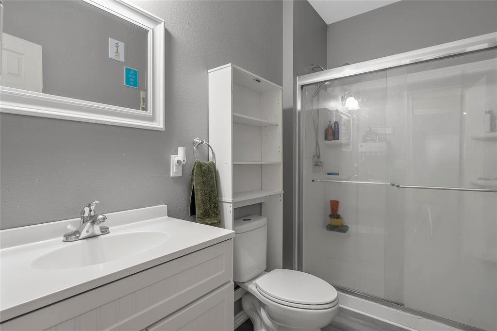 2301 Herring Avenue Waco, TX 76708 - Photo 10 of 14 a bathroom with a sink a mirror a toilet and shower