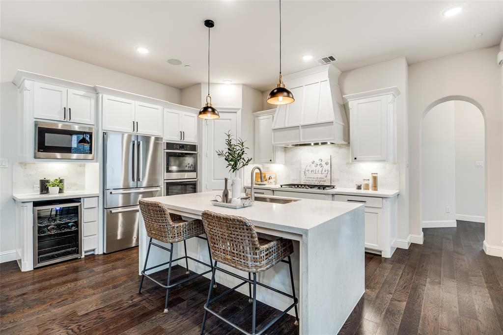 1036 Drew Lane Allen, TX 75013 - Photo 12 of 38 a kitchen with stainless steel appliances granite countertop a stove a refrigerator a oven a sink with a dining table and chairs