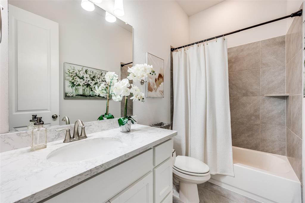 1036 Drew Lane Allen, TX 75013 - Photo 17 of 38 a bathroom with a sink toilet and shower