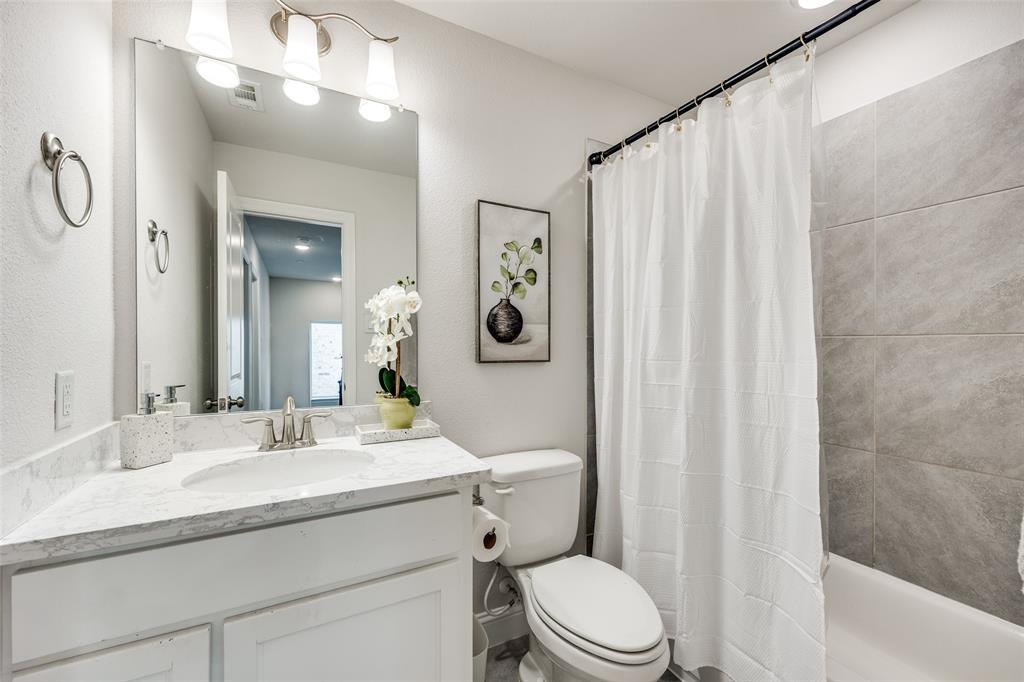 1036 Drew Lane Allen, TX 75013 - Photo 21 of 38 a bathroom with a granite countertop sink toilet and shower