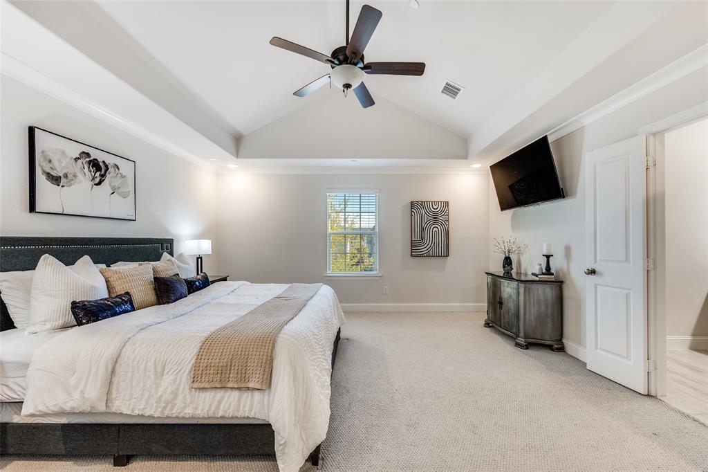1036 Drew Lane Allen, TX 75013 - Photo 27 of 38 a spacious bedroom with a bed and a flat screen tv